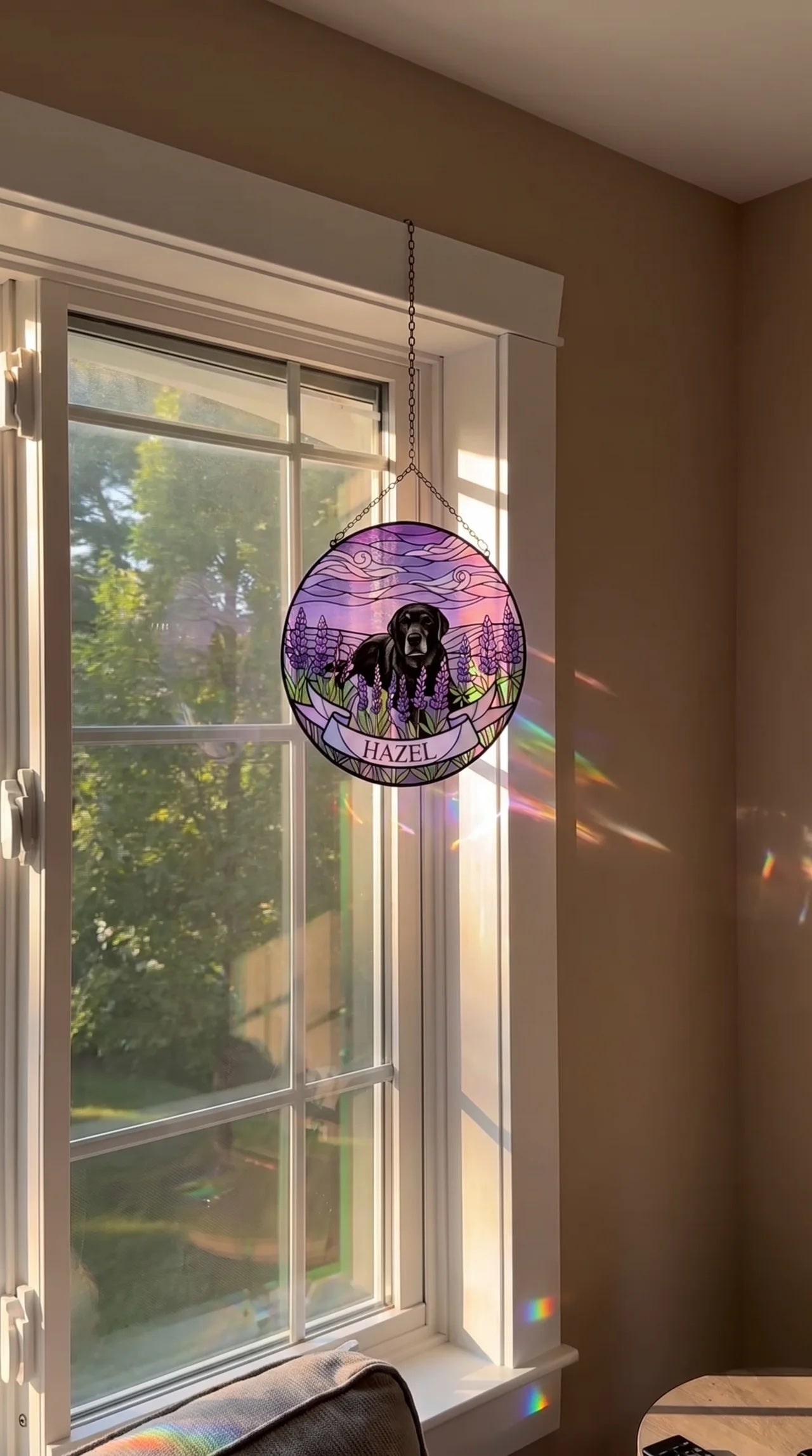 Hazel's finished lavender suncatcher hanging in a sunlit window